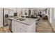 Open-concept kitchen with a spacious island, stainless steel appliances, and seamlessly flowing into the living area at 4504 Ajo Lot#2 Walk, Atlanta, GA 30331