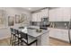 Modern kitchen features a spacious island with seating, stainless steel appliances, and stylish gray backsplash at 4504 Ajo Lot#2 Walk, Atlanta, GA 30331