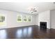 Bright living room featuring dark hardwood floors, a fireplace, and large windows that bring in natural light at 4504 Ajo Lot#2 Walk, Atlanta, GA 30331
