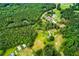 Wide aerial view showcasing the property, surrounded by dense forests and offering privacy and tranquility at 3545 Liberty Rd, Villa Rica, GA 30180