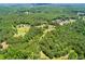Expansive aerial view of wooded property with mature trees, showcasing the home and land at 3545 Liberty Rd, Villa Rica, GA 30180