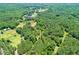 Lush aerial view of wooded property with mature trees, showcasing the home and land at 3545 Liberty Rd, Villa Rica, GA 30180