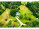 Aerial view of the property showing large yard and a house with a green roof at 3545 Liberty Rd, Villa Rica, GA 30180