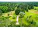 Picturesque aerial view showcasing the property's expansive land, lush greenery, and charming home at 3545 Liberty Rd, Villa Rica, GA 30180