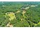 Scenic aerial view of wooded property with mature trees, showcasing the home and land at 3545 Liberty Rd, Villa Rica, GA 30180