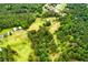 Expansive aerial view of a lush, green landscape featuring a charming home with multiple buildings and sprawling lawn at 3545 Liberty Rd, Villa Rica, GA 30180