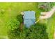 Aerial view of a home with a green roof, surrounded by trees and a well-maintained lawn at 3545 Liberty Rd, Villa Rica, GA 30180