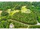 Lush aerial view of a country home surrounded by winding roads and lush greenery at 3545 Liberty Rd, Villa Rica, GA 30180