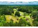 Secluded home surrounded by a dense forest and rolling green fields, offering privacy at 3545 Liberty Rd, Villa Rica, GA 30180