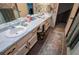 Bathroom featuring double sinks, marble countertop, and unique patterned wallpaper at 3545 Liberty Rd, Villa Rica, GA 30180