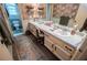 Bathroom with double sinks, patterned wallpaper, and decorative runner rug at 3545 Liberty Rd, Villa Rica, GA 30180