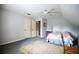 Slanted ceiling bedroom showcases decor, a bed, ceiling fan, and closet at 3545 Liberty Rd, Villa Rica, GA 30180