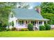 Charming home features a quaint porch and landscaped front yard at 3545 Liberty Rd, Villa Rica, GA 30180