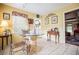 Kitchen featuring a breakfast nook, bright yellow walls, and glass table with sculptural base at 3545 Liberty Rd, Villa Rica, GA 30180