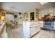 Cozy kitchen featuring white cabinets, stainless steel appliances, and center island with butcher block top at 3545 Liberty Rd, Villa Rica, GA 30180