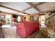 Inviting living room featuring wood paneling, beamed ceilings, and comfortable seating arrangement at 3545 Liberty Rd, Villa Rica, GA 30180