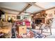 Bright and airy living room featuring exposed beams and a cozy brick fireplace at 3545 Liberty Rd, Villa Rica, GA 30180