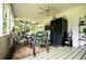 Relaxing covered porch with outdoor seating, ceiling fan, and convenient mini refrigerator for refreshments at 3545 Liberty Rd, Villa Rica, GA 30180