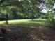 A large, well-maintained yard with mature trees and a golf cart at 3545 Liberty Rd, Villa Rica, GA 30180