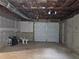 Unfinished basement with garage door offers potential for customization and additional storage at 4232 Chickasaw Trl, Douglasville, GA 30135