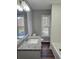 Bright bathroom with granite counters, updated fixtures, and a soaking tub at 4232 Chickasaw Trl, Douglasville, GA 30135