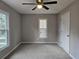 Neutrally painted bedroom offers two windows and a ceiling fan at 4232 Chickasaw Trl, Douglasville, GA 30135