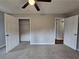 Spacious bedroom with a ceiling fan, carpet and neutral paint; closet and bathroom access at 4232 Chickasaw Trl, Douglasville, GA 30135