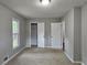 Bedroom featuring a carpeted floor, closet, and access to the hallway and bathroom at 4232 Chickasaw Trl, Douglasville, GA 30135