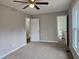 Bedroom with ceiling fan, carpet, neutral paint, and bathroom access at 4232 Chickasaw Trl, Douglasville, GA 30135