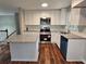 Modern kitchen featuring granite countertops, white cabinets, and stainless steel appliances at 4232 Chickasaw Trl, Douglasville, GA 30135