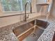 Kitchen sink with stainless steel faucet and granite countertops by a window with natural lighting at 4232 Chickasaw Trl, Douglasville, GA 30135