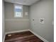 Compact laundry room with laminate floors offers convenience and functionality at 4232 Chickasaw Trl, Douglasville, GA 30135