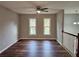 Bright living room featuring hardwood floors, neutral walls, and natural lighting from two large windows at 4232 Chickasaw Trl, Douglasville, GA 30135