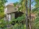 Secluded backyard featuring multi-tiered decks and lush greenery, creating a tranquil and private outdoor living space at 8355 Ainsworth Dr, Cumming, GA 30041
