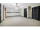 Spacious finished basement with carpet and dark trim at 8355 Ainsworth Dr, Cumming, GA 30041