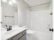 Bright bathroom with white tiled shower and tub, plus a gray vanity at 8355 Ainsworth Dr, Cumming, GA 30041