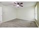 Spacious bedroom with neutral carpet, ceiling fan, and a bright, inviting atmosphere at 8355 Ainsworth Dr, Cumming, GA 30041