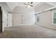 Spacious bedroom with trey ceilings, a ceiling fan, and large windows at 8355 Ainsworth Dr, Cumming, GA 30041