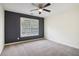 Bedroom featuring neutral carpet, a ceiling fan, and a large window providing ample natural light at 8355 Ainsworth Dr, Cumming, GA 30041