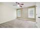 Comfortable bedroom with neutral carpet, two windows, and a ceiling fan for added comfort at 8355 Ainsworth Dr, Cumming, GA 30041