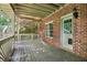 A cozy deck with wooden flooring and railing complemented by a brick wall at 8355 Ainsworth Dr, Cumming, GA 30041
