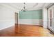 Dining room featuring modern wall decor, hardwood flooring, and an elegant chandelier at 8355 Ainsworth Dr, Cumming, GA 30041
