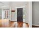 Inviting foyer features hardwood floors and a view to the home's main entrance at 8355 Ainsworth Dr, Cumming, GA 30041