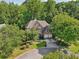 Traditional brick home with mature trees and landscaping at 8355 Ainsworth Dr, Cumming, GA 30041