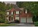 Stately brick home with a charming front porch, two-car garage, and meticulously landscaped yard, offering curb appeal at 8355 Ainsworth Dr, Cumming, GA 30041