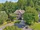 Traditional brick home with mature trees and landscaping at 8355 Ainsworth Dr, Cumming, GA 30041