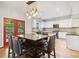 Eat-in kitchen features pendant lighting, center island, stainless appliances, and granite counters at 8355 Ainsworth Dr, Cumming, GA 30041