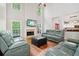 Bright living room features tall ceilings, a cozy fireplace, and expansive windows offering serene views at 8355 Ainsworth Dr, Cumming, GA 30041