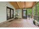 Inviting screened porch featuring exposed wood ceiling, classic lighting, and ample seating at 8355 Ainsworth Dr, Cumming, GA 30041