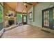 Relaxing screened-in porch with natural light, wood floors, and a stone fireplace at 8355 Ainsworth Dr, Cumming, GA 30041